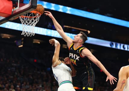 Nov 15, 2023; Phoenix, Arizona, USA; Phoenix Suns forward Drew Eubanks (right) slam dunks the ball against Minnesota Timberwolves center Karl-Anthony Towns in the first half at Footprint Center. Mandatory Credit: Mark J. Rebilas-USA TODAY Sports