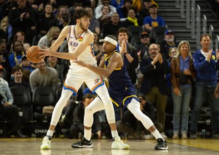 Nov 16, 2023; San Francisco, California, USA; Oklahoma City Thunder center Chet Holmgren (7) looks to pass around Golden State Warriors guard Moses Moody (4) during the third quarter at Chase Center. Mandatory Credit: D. Ross Cameron-USA TODAY Sports