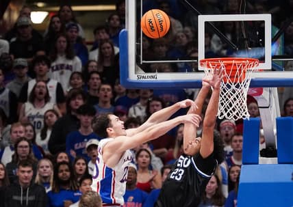 Nov 28, 2023; Lawrence, Kansas, USA; Kansas Jayhawks guard Nicolas Timberlake (25) shoots as Eastern Illinois Panthers forward Rodolfo Bolis (23) attempts to block during the first half at Allen Fieldhouse. Mandatory Credit: Denny Medley-USA TODAY Sports