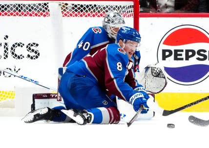 2Dec 11, 2023; Denver, Colorado, USA; Colorado Avalanche defenseman Cale Makar (8) and Colorado Avalanche goaltender Alexandar Georgiev (40) reach for the puck in the second period against the Calgary Flames at Ball Arena. Mandatory Credit: Ron Chenoy-USA TODAY Sports