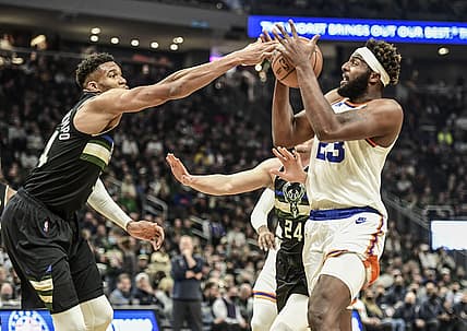 Nov 5, 2021; Milwaukee, Wisconsin, USA; Milwaukee Bucks forward Giannis Antetokounmpo (34) tries to steal the ball from New York Knicks center Mitchell Robinson (23) in the first quarter at Fiserv Forum. Mandatory Credit: Benny Sieu-USA TODAY Sports