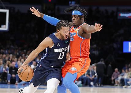 Dec 12, 2021; Oklahoma City, Oklahoma, USA; Dallas Mavericks guard Jalen Brunson (13) drives to the basket as Oklahoma City Thunder forward Luguentz Dort (5) defends during the second quarter at Paycom Center. Mandatory Credit: Alonzo Adams-USA TODAY Sports