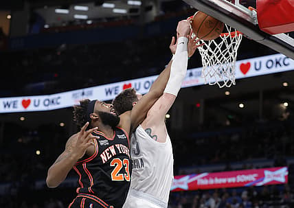 Dec 31, 2021; Oklahoma City, Oklahoma, USA; New York Knicks center Mitchell Robinson (23) and Oklahoma City Thunder center Mike Muscala (33) reach for the ball during the second quarter at Paycom Center. Mandatory Credit: Alonzo Adams-USA TODAY Sports