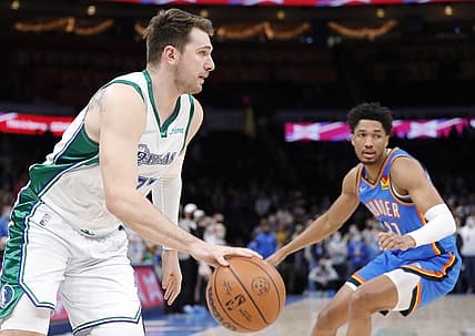 Jan 2, 2022; Oklahoma City, Oklahoma, USA; Dallas Mavericks guard Luka Doncic (77) drives to the basket around Oklahoma City Thunder guard Aaron Wiggins (21) during the first quarter at Paycom Center. Mandatory Credit: Alonzo Adams-USA TODAY Sports