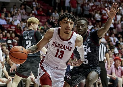 Mar 2, 2022; Tuscaloosa, Alabama, USA; Alabama Crimson Tide guard Jahvon Quinerly (13) drives the baseline around Texas A&M Aggies guard Hassan Diarra (5) during the second half at Coleman Coliseum. Mandatory Credit: Butch Dill-USA TODAY Sports
