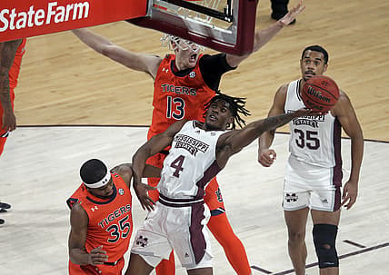 Mar 2, 2022; Starkville, Mississippi, USA; Mississippi State Bulldogs guard Cameron Matthews (4) drives to the basket as Auburn Tigers forward Walker Kessler (13) defends during the first half at Humphrey Coliseum. Mandatory Credit: Petre Thomas-USA TODAY Sports
