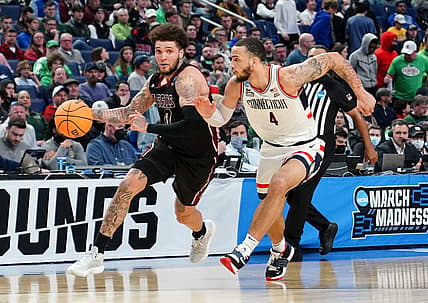 Mar 17, 2022; Buffalo, NY, USA; New Mexico State Aggies guard Teddy Allen (0) drives against Connecticut Huskies guard Tyrese Martin (4) in the first half during the first round of the 2022 NCAA Tournament at KeyBank Center. Mandatory Credit: Gregory Fisher-USA TODAY Sports
