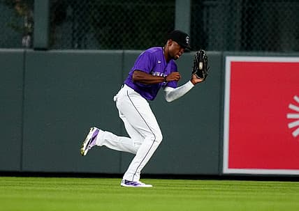Aug 12, 2022; Denver, Colorado, USA; Colorado Rockies center fielder Wynton Bernard (36) fields the ball the sixth inning against the Arizona Diamondbacks at Coors Field. Mandatory Credit: Ron Chenoy-USA TODAY Sports