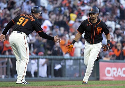 Aug 13, 2022; San Francisco, California, USA; San Francisco Giants designated hitter LaMonte Wade Jr. (right) celebrates with third base coach Mark Hallberg (91) after hitting a solo home run against the Pittsburgh Pirates in the third inning at Oracle Park. Mandatory Credit: D. Ross Cameron-USA TODAY Sports