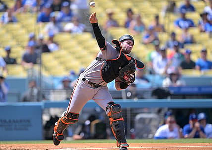 Sep 7, 2022; Los Angeles, California, USA;  San Francisco Giants catcher Austin Wynns (14) throws to first for a double play in the third inning against the Los Angeles Dodgers at Dodger Stadium. Mandatory Credit: Jayne Kamin-Oncea-USA TODAY Sports