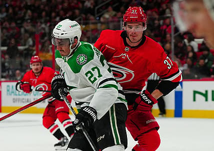 Feb 24, 2024; Raleigh, North Carolina, USA;  Dallas Stars left wing Mason Marchment (27) checks Carolina Hurricanes right wing Andrei Svechnikov (37) during the first period at PNC Arena. Mandatory Credit: James Guillory-USA TODAY Sports