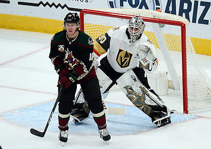 Jan 22, 2021; Glendale, Arizona, USA; Arizona Coyotes center Christian Dvorak (18) screens Vegas Golden Knights goaltender Robin Lehner (90) during the second period at Gila River Arena. Mandatory Credit: Joe Camporeale-USA TODAY Sports
