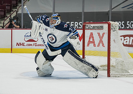 Mar 22, 2021; Vancouver, British Columbia, CAN; Winnipeg Jets goalie Connor Hellebuyck (37) makes a save against the Vancouver Canucks  in the first period at Rogers Arena. Mandatory Credit: Bob Frid-USA TODAY Sports
