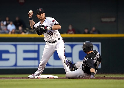 Apr 29, 2021; Phoenix, Arizona, USA; Arizona Diamondbacks second baseman Josh VanMeter (19) turns the double play while avoiding Colorado Rockies second baseman Garrett Hampson (1) in the first inning at Chase Field. Mandatory Credit: Rick Scuteri-USA TODAY Sports