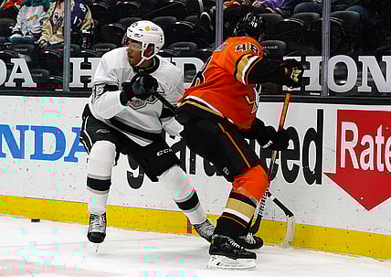 Apr 30, 2021; Anaheim, California, USA; Los Angeles Kings center Quinton Byfield (55) plays for the puck against Anaheim Ducks center Isac Lundestrom (48) during the first period at Honda Center. Mandatory Credit: Gary A. Vasquez-USA TODAY Sports