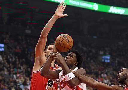 Oct 25, 2021; Toronto, Ontario, CAN; Toronto Raptors forward OG Anunoby (center) has a shot blocked by Chicago Bulls center Nikola Vucevic (9) in the first half at Scotiabank Arena. Mandatory Credit: Dan Hamilton-USA TODAY Sports