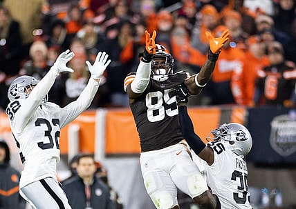 Dec 20, 2021; Cleveland, Ohio, USA; Cleveland Browns tight end David Njoku (85) leaps for the ball along with Las Vegas Raiders defensive back Dallin Leavitt (32) and cornerback Brandon Facyson (35) during the fourth quarter at FirstEnergy Stadium. Mandatory Credit: Scott Galvin-USA TODAY Sports