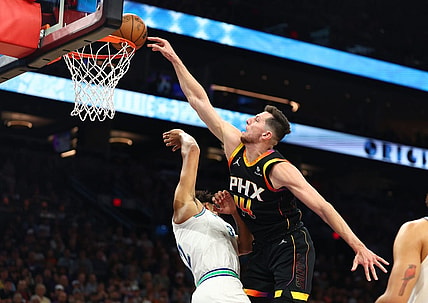Nov 15, 2023; Phoenix, Arizona, USA; Phoenix Suns forward Drew Eubanks (right) slam dunks the ball against Minnesota Timberwolves center Karl-Anthony Towns in the first half at Footprint Center. Mandatory Credit: Mark J. Rebilas-USA TODAY Sports