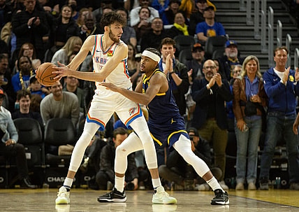Nov 16, 2023; San Francisco, California, USA; Oklahoma City Thunder center Chet Holmgren (7) looks to pass around Golden State Warriors guard Moses Moody (4) during the third quarter at Chase Center. Mandatory Credit: D. Ross Cameron-USA TODAY Sports