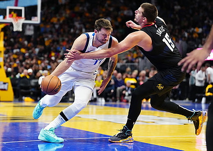 Nov 3, 2023; Denver, Colorado, USA; Denver Nuggets center Nikola Jokic (15) fouls Dallas Mavericks guard Luka Doncic (77) in the third quarter at Ball Arena. Mandatory Credit: Ron Chenoy-USA TODAY Sports
