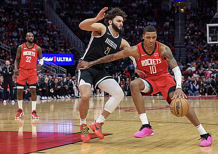 Dec 13, 2023; Houston, Texas, USA; Houston Rockets forward Jabari Smith Jr. (10) dribbles against Memphis Grizzlies forward David Roddy (21) in the second half at Toyota Center. Mandatory Credit: Thomas Shea-USA TODAY Sports