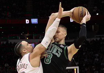 Jan 21, 2024; Houston, Texas, USA; Boston Celtics center Kristaps Porzingis (8) is guarded by Houston Rockets forward Dillon Brooks (9) in the second half at Toyota Center. Mandatory Credit: Thomas Shea-USA TODAY Sports