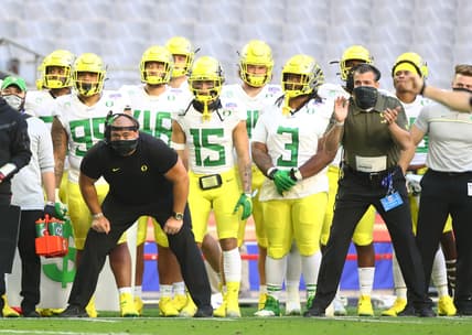 Jan 2, 2021; Glendale, AZ, USA; Oregon Ducks defensive line coach Joe Salave'a (left) alongside head coach Mario Cristobal against the Iowa State Cyclones in the Fiesta Bowl at State Farm Stadium. Mandatory Credit: Mark J. Rebilas-USA TODAY Sports