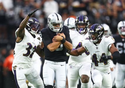 Sep 13, 2021; Paradise, Nevada, USA; Las Vegas Raiders quarterback Marcus Mariota (8) is tackled by Baltimore Ravens defensive back DeShon Elliott (32) and cornerback Marlon Humphrey (44) during the first half at Allegiant Stadium. Mandatory Credit: Mark J. Rebilas-USA TODAY Sports