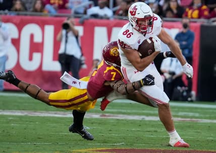 Oct 9, 2021; Los Angeles, California, USA; USC Trojans safety Chase Williams (7) makes a diving tackle on Utah Utes tight end Dalton Kincaid (86) during the second quarter at United Airlines Field at Los Angeles Memorial Coliseum. Mandatory Credit: Robert Hanashiro-USA TODAY Sports