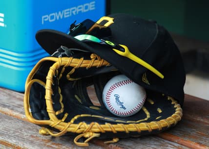Jul 28, 2018; Pittsburgh, PA, USA; A Pittsburgh Pirates glove and cap are seen in the dugout  during a game against the New York Mets at PNC Park. Mandatory Credit: Charles LeClaire-USA TODAY Sports