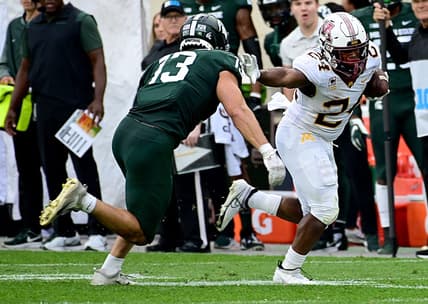 Sep 24, 2022; East Lansing, Michigan, USA;  Minnesota Golden Gophers running back Mohamed Ibrahim (24) pushes away tackler Michigan State Spartans linebacker Ben VanSumeren (13) in the second quarter at Spartan Stadium. Mandatory Credit: Dale Young-USA TODAY Sports