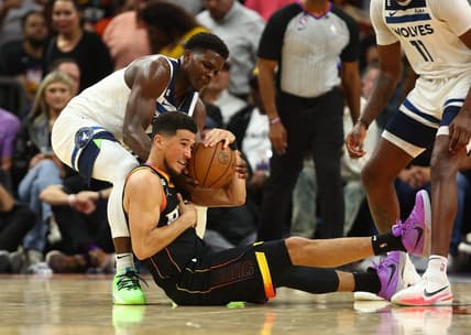 Nov 1, 2022; Phoenix, Arizona, USA; Phoenix Suns guard Devin Booker (bottom) battles for a loose ball with Minnesota Timberwolves guard Anthony Edwards in the first half at Footprint Center. Mandatory Credit: Mark J. Rebilas-USA TODAY Sports