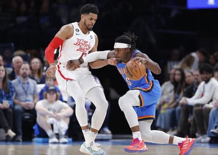 Dec 31, 2022; Oklahoma City, Oklahoma, USA; Oklahoma City Thunder guard Luguentz Dort (5) drives against Philadelphia 76ers forward Tobias Harris (12) during the first quarter at Paycom Center. Mandatory Credit: Alonzo Adams-USA TODAY Sports