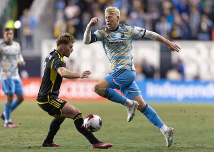 Feb 25, 2023; Philadelphia, Pennsylvania, USA; Philadelphia Union defender Jakob Glesnes (5) dribbles past Columbus Crew SC midfielder Aidan Morris (8) during the first half at Subaru Park. Mandatory Credit: Bill Streicher-USA TODAY Sports
