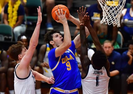 Nov 20, 2023; Honolulu, Hawaii, USA;  UCLA Bruins forward Berke Buyuktuncel (9) shoots the ball against Marquette Golden Eagles guard Kam Jones (1) during the first period at SimpliFi Arena at Stan Sheriff Center. Mandatory Credit: Steven Erler-USA TODAY Sports
