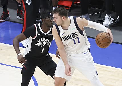 May 30, 2021; Dallas, Texas, USA; Dallas Mavericks guard Luka Doncic (77) dribbles as LA Clippers guard Reggie Jackson (1) defends during the third quarter in game four in the first round of the 2021 NBA Playoffs at American Airlines Center. Mandatory Credit: Kevin Jairaj-USA TODAY Sports