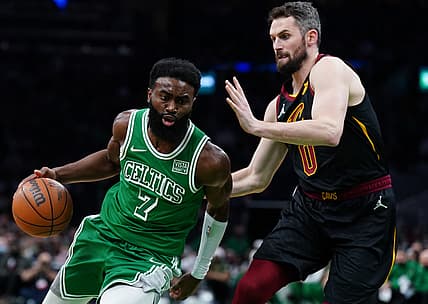 Dec 22, 2021; Boston, Massachusetts, USA; Boston Celtics guard Jaylen Brown (7) drives the ball against Cleveland Cavaliers forward Kevin Love (0) in the half quarter at TD Garden. Mandatory Credit: David Butler II-USA TODAY Sports