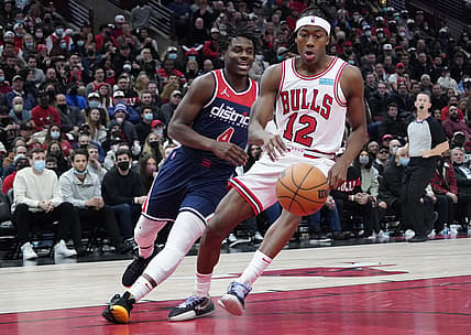 Jan 7, 2022; Chicago, Illinois, USA; Chicago Bulls guard Ayo Dosunmu (12) steals the ball from Washington Wizards guard Aaron Holiday (4) during the second half at United Center. Mandatory Credit: David Banks-USA TODAY Sports