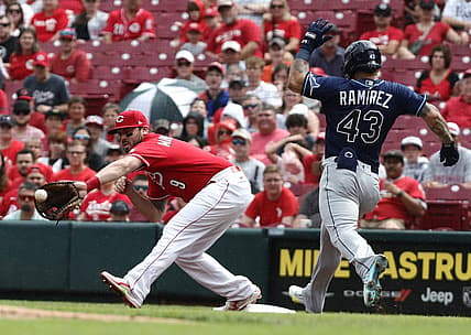 Jul 9, 2022; Cincinnati, Ohio, USA; Tampa Bay Rays left fielder Harold Ramirez (43) is out at first against Cincinnati Reds first baseman Mike Moustakas (9) during the first inning at Great American Ball Park. Mandatory Credit: David Kohl-USA TODAY Sports