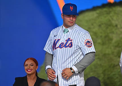 Jul 17, 2022; Los Angeles, CA, USA;  Kevin Parada puts on a jersey after he was selected by the New York Mets as the 11th player in the MLB draft at XBox Plaza at LA Live. Mandatory Credit: Jayne Kamin-Oncea-USA TODAY Sports
