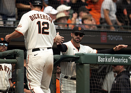 Aug 18, 2021; San Francisco, California, USA; San Francisco Giants manager Gabe Kapler (19) greets left fielder Alex Dickerson (12) after he scored on a double by pinch hitter Wilmer Flores during the third inning against the New York Mets at Oracle Park. Mandatory Credit: D. Ross Cameron-USA TODAY Sports