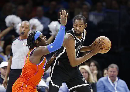Nov 14, 2021; Oklahoma City, Oklahoma, USA; Oklahoma City Thunder forward Luguentz Dort (5) defends Brooklyn Nets forward Kevin Durant (7) on a play during the second half at Paycom Center. Brooklyn won 120-96. Mandatory Credit: Alonzo Adams-USA TODAY Sports