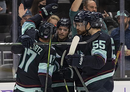 Nov 21, 2021; Seattle, Washington, USA;  Seattle Kraken center Jaden Schwartz (17), defenseman Adam Larsson (6) secon from right, defenseman Jeremy Lauzon (55) celebrate a goal by center Calle Jarnkrok (19 during the second period against the Washington Capitals)at Climate Pledge Arena. Mandatory Credit: Stephen Brashear-USA TODAY Sports