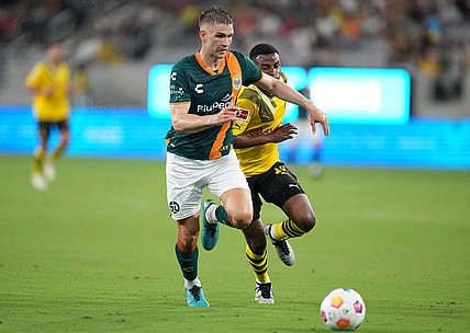 Jul 27, 2023; San Diego, California, USA;  San Diego Loyal defender Grant Stoneman (5) battles for the ball against Borussia Dortmund forward Youssoufa Moukoko (18) during the first half at Snapdragon Stadium. Mandatory Credit: Ray Acevedo-USA TODAY Sports