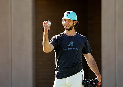 Arizona Diamondbacks pitcher Zac Gallen studies his grip during spring training workouts at Salt River Fields at Talking Stick in Scottsdale on Feb. 22, 2024.