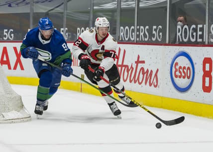 Apr 24, 2021; Vancouver, British Columbia, CAN;  Vancouver Canucks forward J.T. Miller (9) checks Ottawa Senators defenseman Thomas Chabot (72) in the second period at Rogers Arena. Mandatory Credit: Bob Frid-USA TODAY Sports