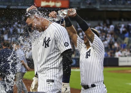 Oct 3, 2021; Bronx, New York, USA; New York Yankees right fielder Aaron Judge (99) is doused with water after his game winning RBI single to defeat the Tampa Bay Rays 1-0 and clinch a wildcard playoff spot at Yankee Stadium. Mandatory Credit: Wendell Cruz-USA TODAY Sports