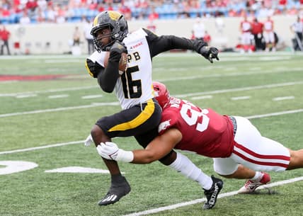 Oct 23, 2021; Little Rock, Arkansas, USA; Arkansas Pine Bluff Golden Lions wide receiver Dae'eion Dawkins (16) runs after a catch as Arkansas Razorbacks defensive lineman Isaiah Nichols (93) makes a tackle during the first quarter at War Memorial Stadium. Mandatory Credit: Nelson Chenault-USA TODAY Sports