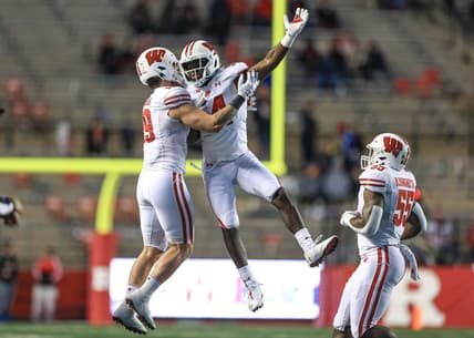 Nov 6, 2021; Piscataway, New Jersey, USA; Wisconsin Badgers linebacker Jordan Turner (54) celebrates his interception with linebacker Nick Herbig (19) and linebacker Maema Njongmeta (55) during the second half against the Rutgers Scarlet Knights at SHI Stadium. Mandatory Credit: Vincent Carchietta-USA TODAY Sports