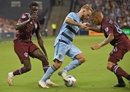 Aug 28, 2021; Kansas City, Kansas, USA;  Sporting Kansas City forward Johnny Russell (7) dribbles the ball up field against Colorado Rapids defender Lucas Esteves (66) during the second half at Children's Mercy Park. Mandatory Credit: Peter Aiken-USA TODAY Sports